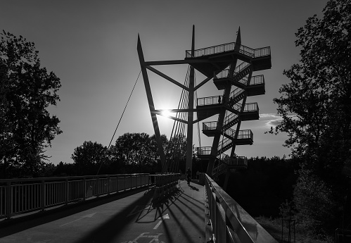 A pedestrian and bicycle footbridge in the town of Owinska near Poznan, Poland in grayscale