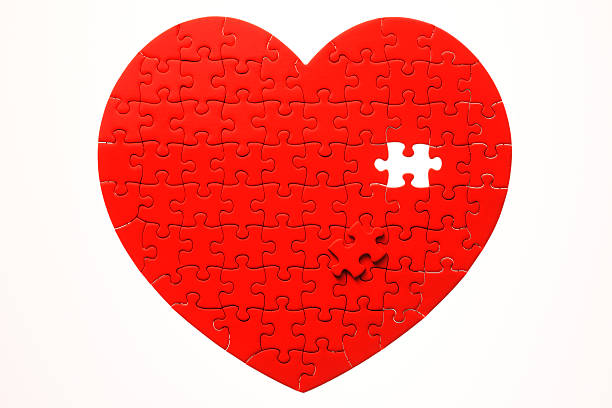 istock Heart shape jigsaw puzzle with one missing piece laying aside 166497202