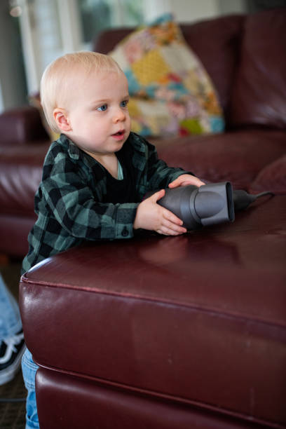 First Steps Young Toddler learning to Walk Young toddler learning to walk and move around the house, interacting with toys. walking into glass door stock pictures, royalty-free photos & images