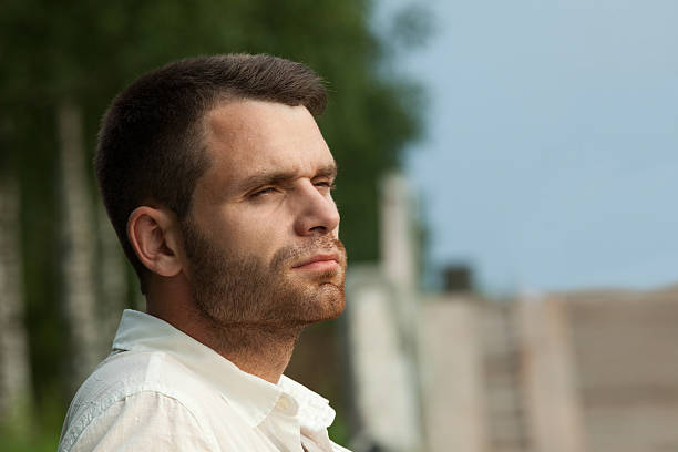 istock Sad man portrait in summer park look at sunset 166502135