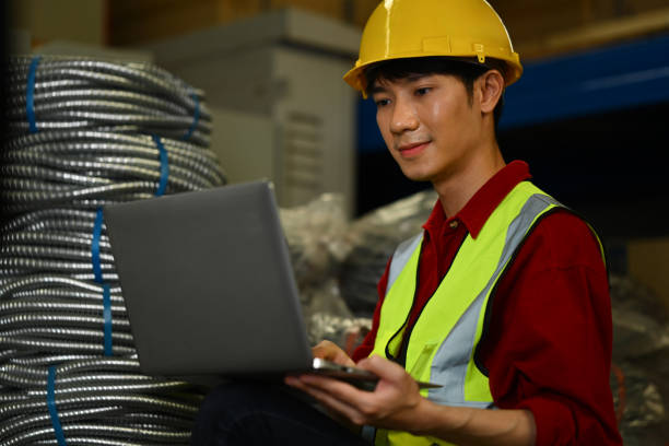 istock Asian male manager wearing hardhat using laptop and checking inventory in a warehouse 1665026927