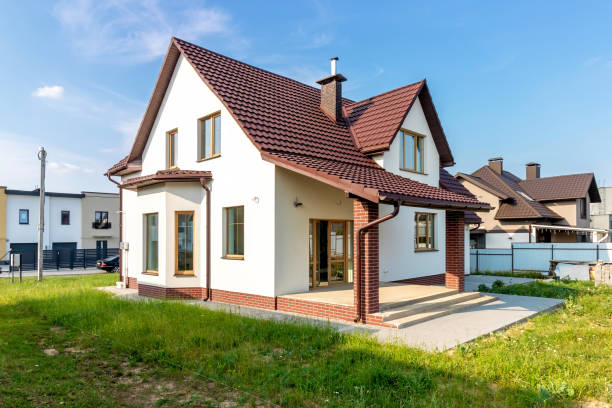 istock A white house with a green lawn and a blue sky 1665037575
