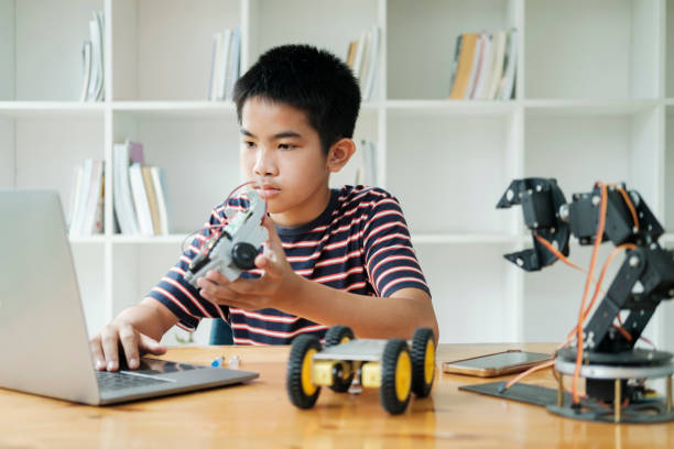 istock Asian teenager doing robot project in science classroom. technology of robotics programing and STEM education concept. 1665074663