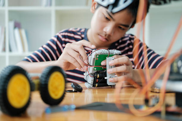 istock Asian teenager doing robot project in science classroom. technology of robotics programing and STEM education concept. 1665074664