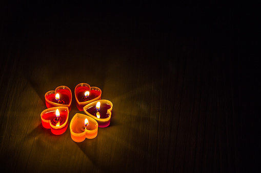 Light a heart-shaped scented candle in the dark.