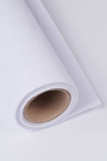 istock Soft felt textile material white color, colorful texture fabric roll closeup 1665105182
