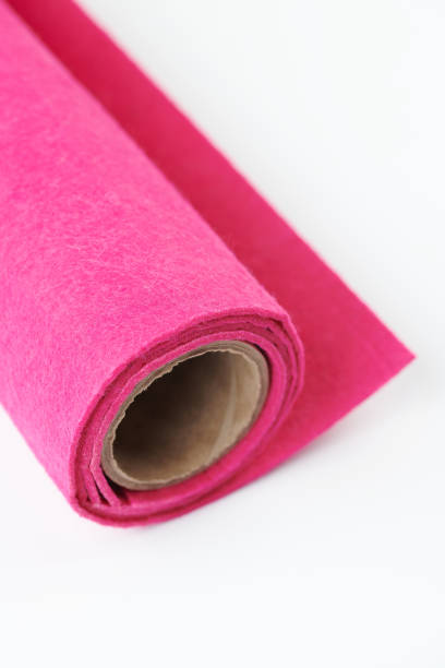 istock Soft felt textile material of pink color, colorful texture fabric roll close-up 1665105694