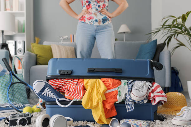 istock Disappointed woman packing for a journey 1665106784
