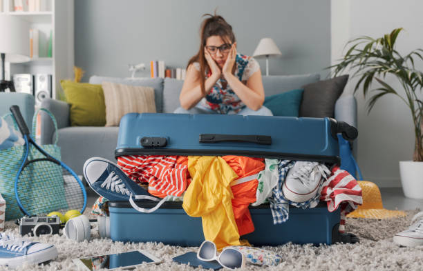 istock Stressed woman packing for a vacation 1665107855