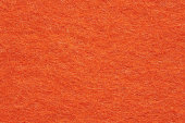 Soft felt textile material bright orange colors, colorful texture flap fabric background closeup