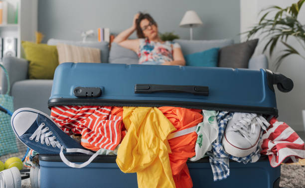 istock Stressed woman packing for a vacation 1665115402