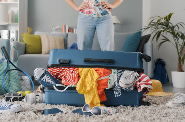 istock Disappointed woman packing for a journey 1665116450