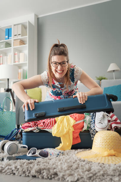 istock Stressed woman preparing her luggage 1665119057