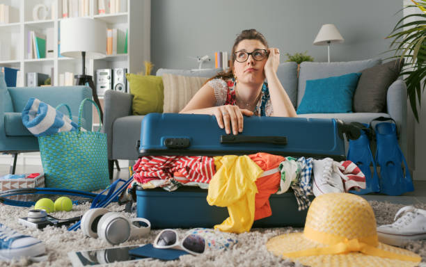 istock Exhausted sad woman packing her luggage 1665119090