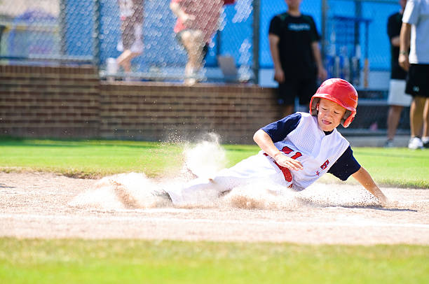 istock Youth league baseball player sliding home. 166514721