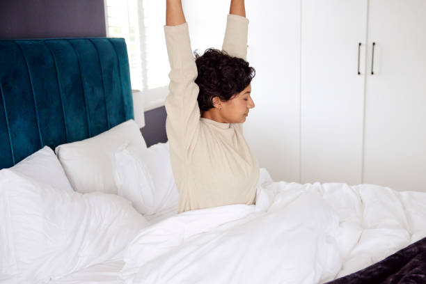 istock Morning Stretch: Young Woman in Bed 1665148907
