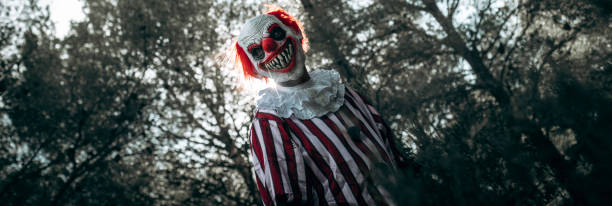 istock mad evil clown in the woods, banner format 1665160901
