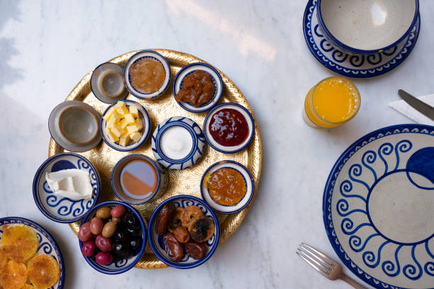 Table with Moroccan dishes with sauces, jams and orange juice