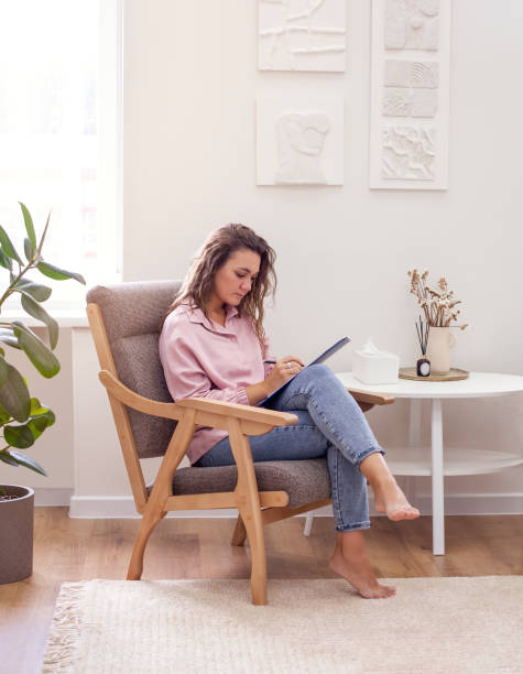 istock young woman working while sitting at home in a chair 1665165838