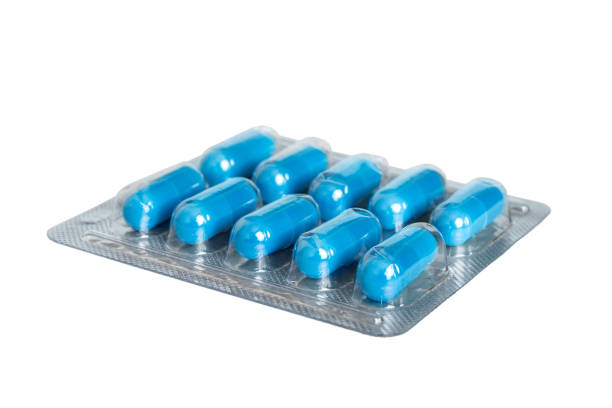 istock Blister package with Vitamin on color background. Medicine pills on a light background. Medicines and prescription pills flat lay background. blue medical tablets in blister 1665181751