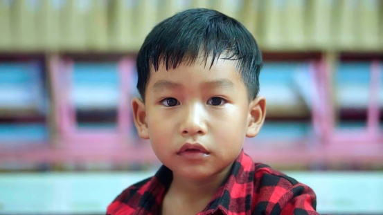 Asian preschoole boy Enjoying a lighthearted moment in class. Back to school concept.