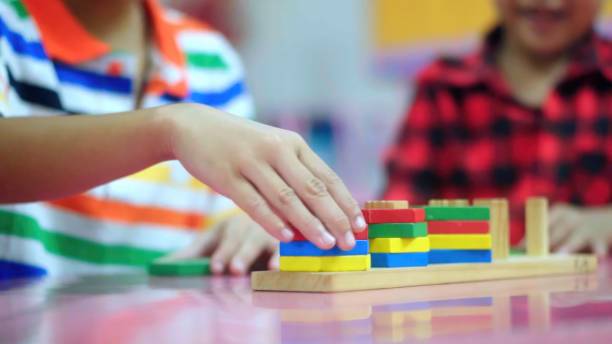 istock Close up hand children playing with didactic toys.Education, elementary school. 1665185217