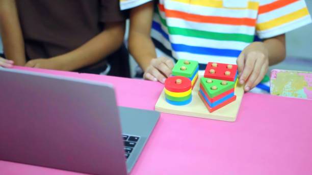 istock Close up hand children playing with didactic toys. Education, elementary school, learning. 1665185592