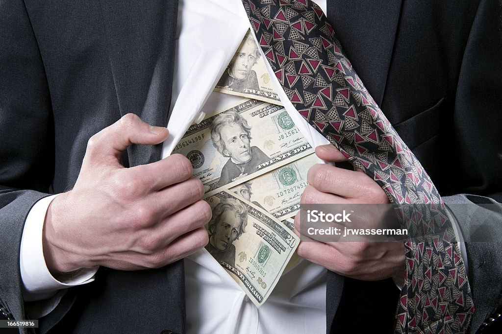 Money to Hide Concept photo for hidden money showing a businessman pulling back his shirt exposing twenty dollar bills Adult Stock Photo