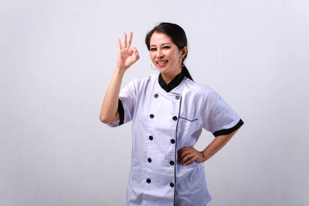 istock Female Asian chef showing OK hand sign gesture 1665212194