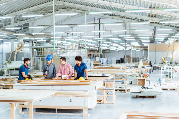 istock Architects, engineers and blue collar staff working together in modern factory 1665221618