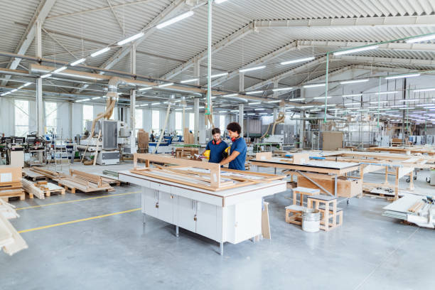 istock Engineers discussing ongoing project in modern hall in factory. Both employees wearing protective equipment 1665221619