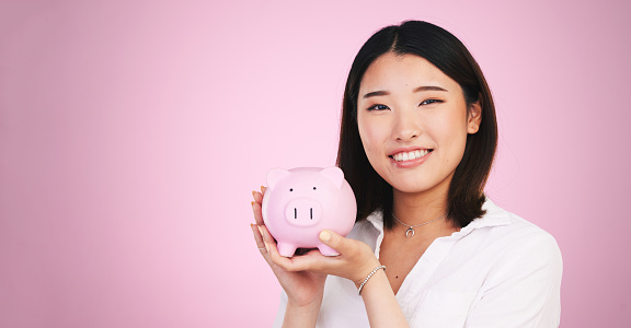 Piggy bank, savings and finance, woman in portrait and mockup space with money isolated on pink background. Budget, future and cash, investment and profit with container for coins and bank in studio