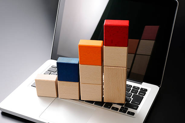 Wood toy blocks bar chart on laptop