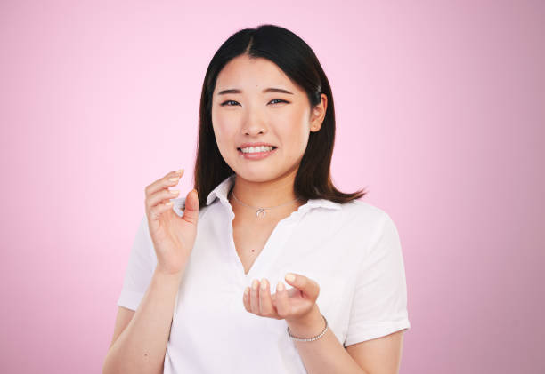 istock Portrait, confused and question with an asian woman on a pink background in studio for problem solving. Face, doubt and why with a young female person thinking about a mistake, error or fail 1665231384