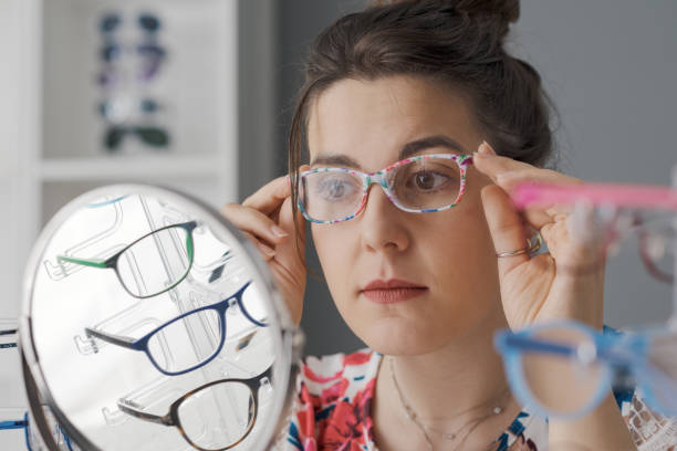 istock Young woman choosing her new glasses 1665240704