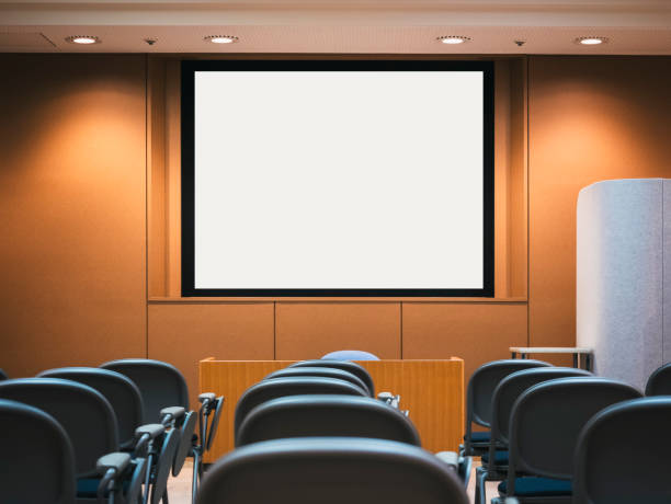 istock Mock up projector screen conference room with seats 1665260811