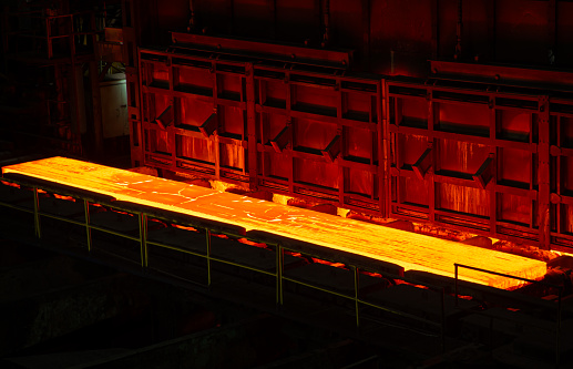 Blast furnace slag and pig iron tapping. Molten metal and slag are poured into a ladle. Metallurgical industry.