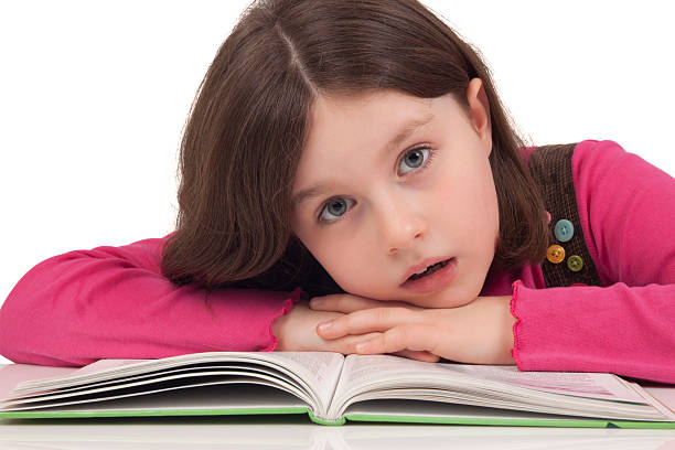 istock Beautiful little girl reading a book 166526348