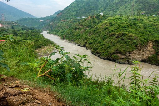 Sutlej or Satluj River flowing through the valleys of Himachal Pradesh. Monsoon season in India.