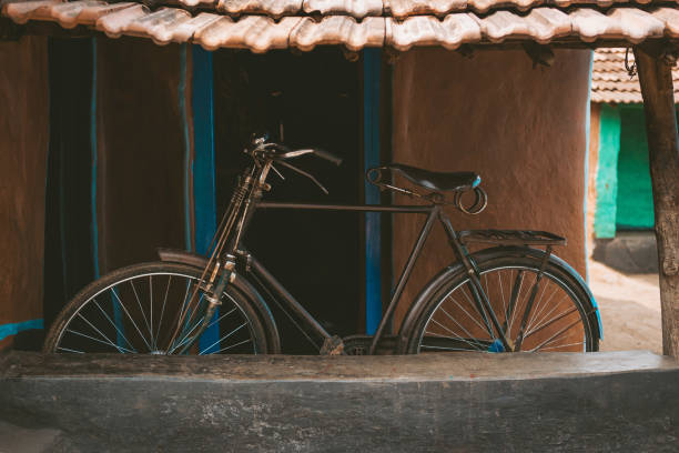 istock an old bicycle in front of a small house 1665331858