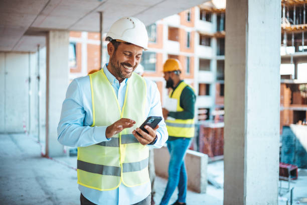 istock Shot of a young businessman using his smartphone while on a construction site. 1665337896