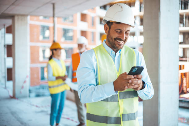 istock Shot of a young businessman using his smartphone while on a construction site. 1665338475
