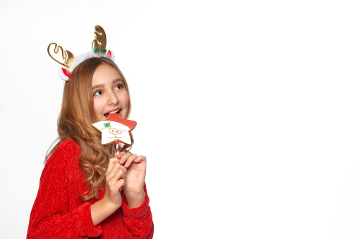 little smiling girl hold gingerbread santa on stick in hands on white background