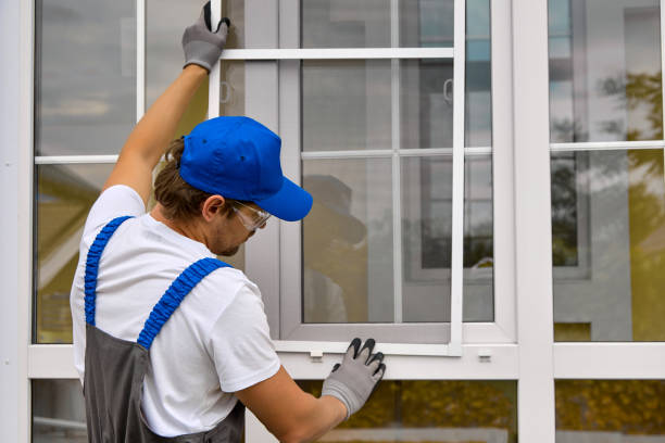istock Wizard installs the mesh in the plastic fasteners on the white window 1665363063