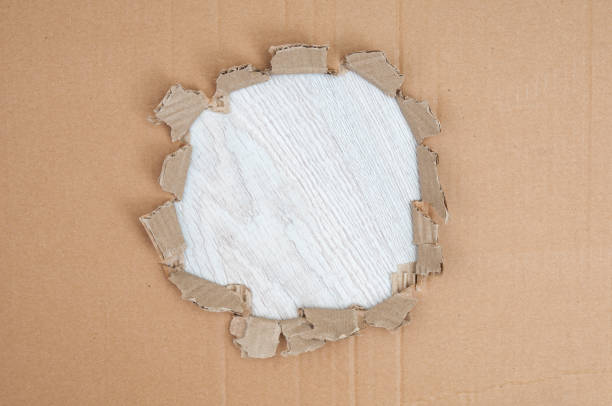 istock Torn edge cardboard corrugated  on a wooden  background 1665367493