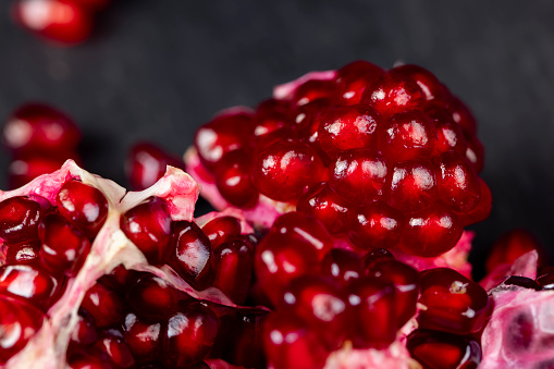 peeled red ripe pomegranate with red sweet grains, juicy pomegranate seeds of red color