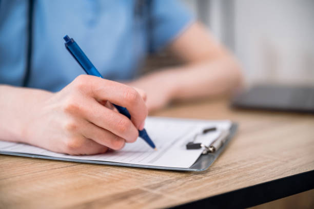istock Selective focus on nursery hand filling medical document or patient card 1665390692