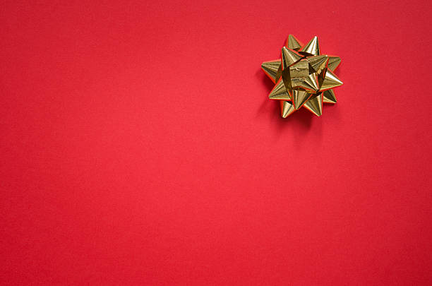 Gold bow on christmas red background http://dl.dropbox.com/u/34112912/a/natale.jpg christmas paper photos stock pictures, royalty-free photos & images