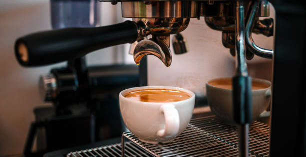 istock Coffee extraction from the coffee machine with a portafilter pouring coffee into a cup,Espresso pouring from the coffee machine at coffee shop 1665407011