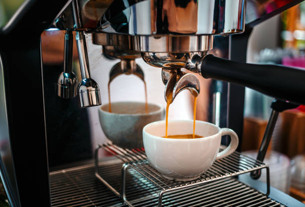 istock Coffee extraction from the coffee machine with a portafilter pouring coffee into a cup,Espresso pouring from the coffee machine at coffee shop 1665407013
